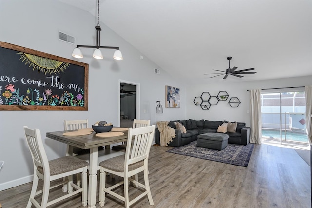 dining room featuring visible vents, wood finished floors, baseboards, and ceiling fan