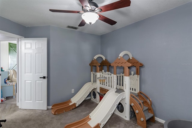 bedroom with carpet flooring, baseboards, visible vents, and ceiling fan