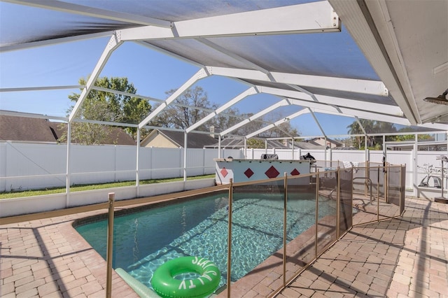 view of swimming pool with a patio area, a fenced in pool, glass enclosure, and a fenced backyard