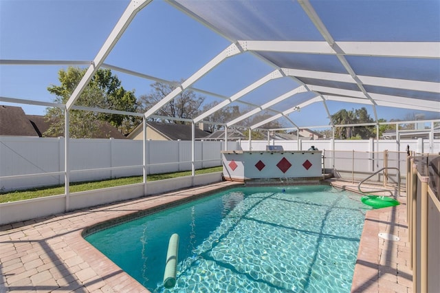 view of swimming pool featuring glass enclosure, a patio, a fenced backyard, and a fenced in pool