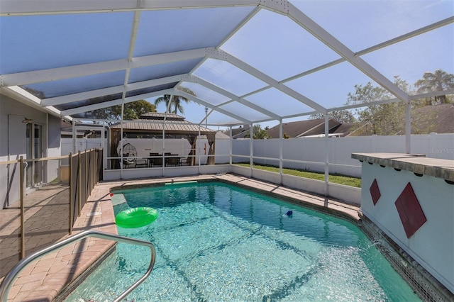 view of swimming pool featuring a fenced in pool, a patio, a lanai, and fence