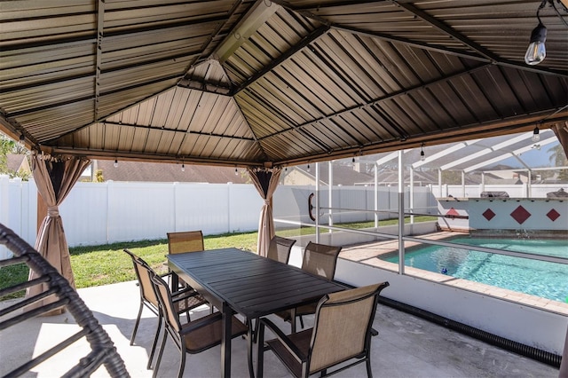 exterior space with outdoor dining area, a patio, a fenced backyard, a fenced in pool, and a lanai