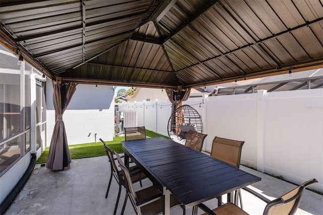 view of patio / terrace with a gazebo, outdoor dining area, and a fenced backyard