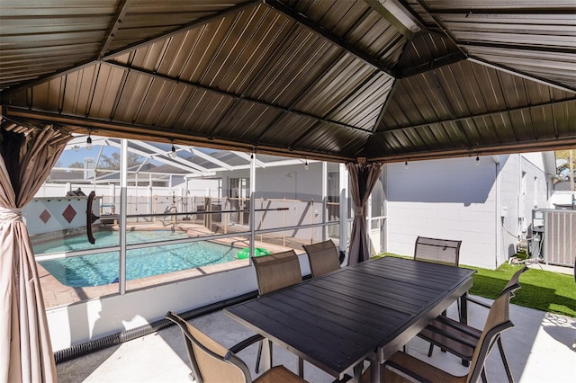 exterior space featuring outdoor dining space, a patio, a fenced in pool, central AC, and a lanai