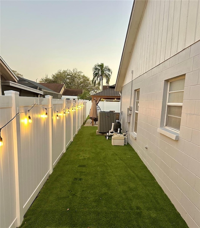 view of yard with a gazebo, central AC unit, and a fenced backyard