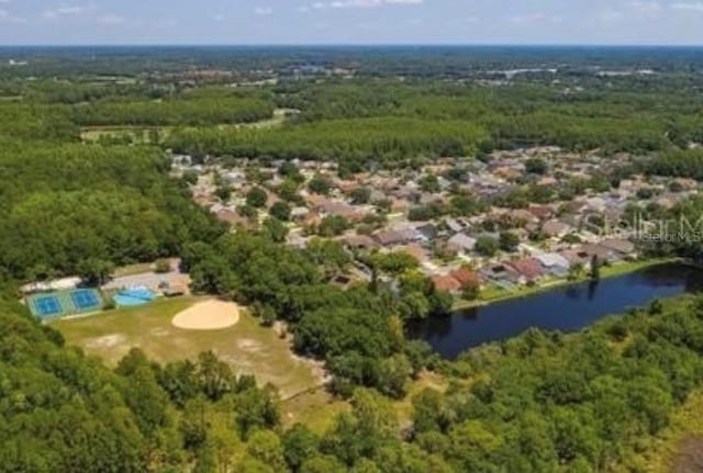 aerial view featuring a view of trees and a water view