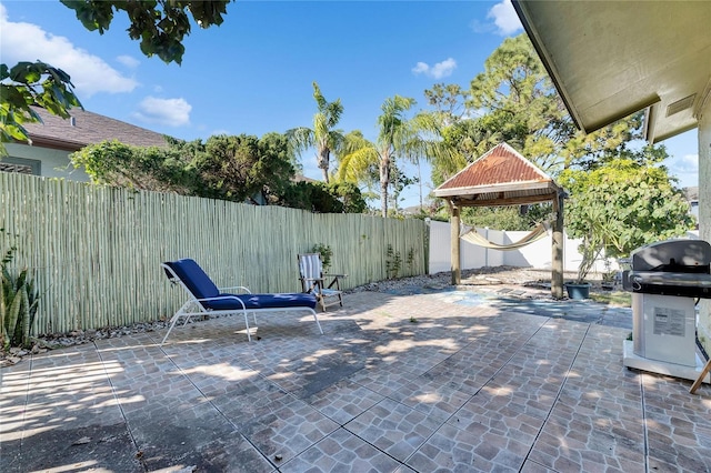 view of patio featuring a grill and a fenced backyard