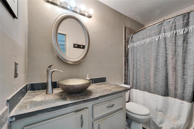 bathroom featuring vanity, toilet, and a shower with curtain