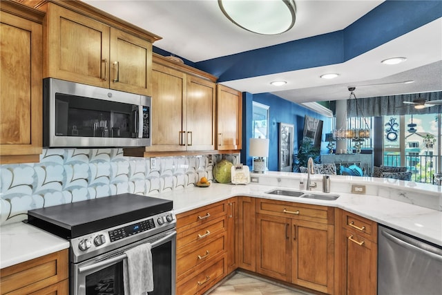 kitchen with a sink, brown cabinets, and stainless steel appliances