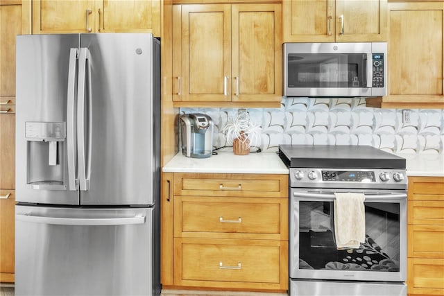 kitchen featuring light countertops, backsplash, and stainless steel appliances