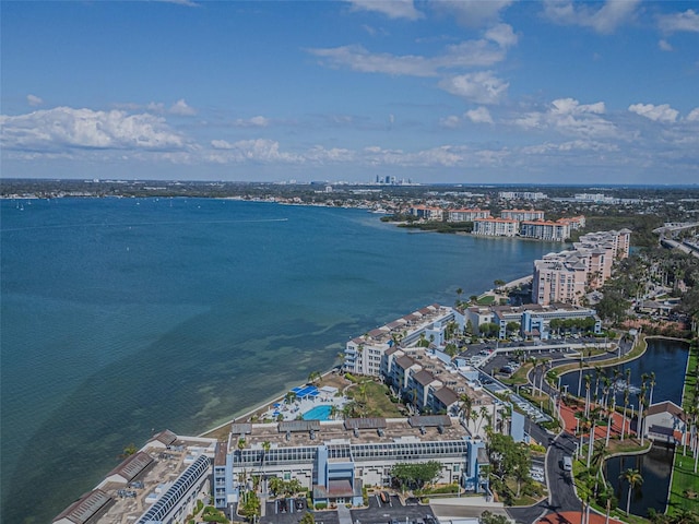 birds eye view of property with a water view and a city view