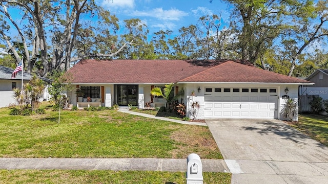 single story home with stucco siding, an attached garage, concrete driveway, and a front yard