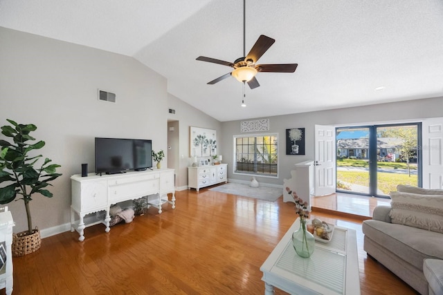 living area with a ceiling fan, wood finished floors, visible vents, high vaulted ceiling, and baseboards