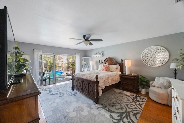 bedroom with visible vents, wood finished floors, a ceiling fan, and access to outside