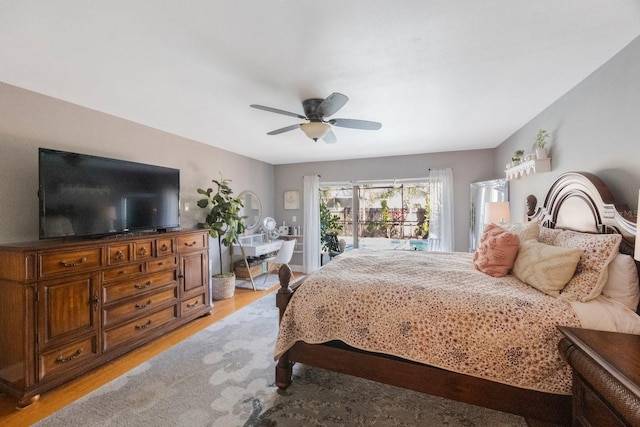 bedroom with light wood-type flooring, ceiling fan, and access to outside