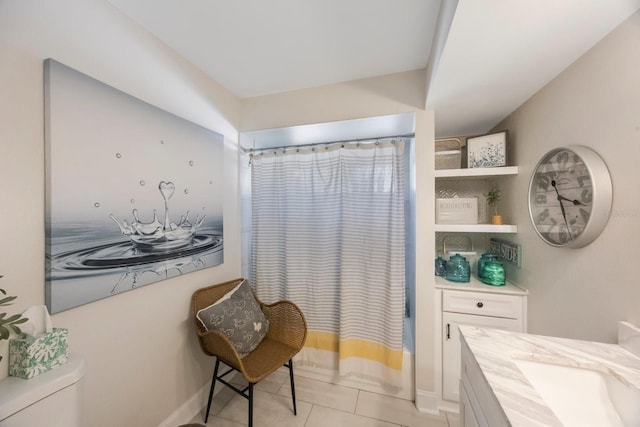 bathroom featuring vanity, tile patterned floors, toilet, and shower / bath combo with shower curtain