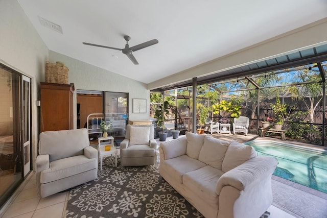 living area featuring visible vents, a sunroom, ceiling fan, vaulted ceiling, and tile patterned floors