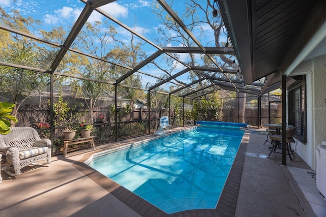 view of pool featuring a patio area, a fenced backyard, and a lanai