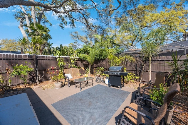 view of patio with a grill and a fenced backyard