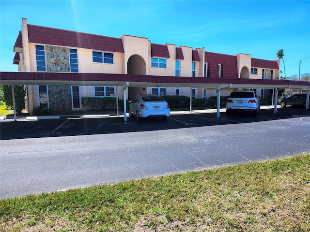 view of building exterior featuring covered parking