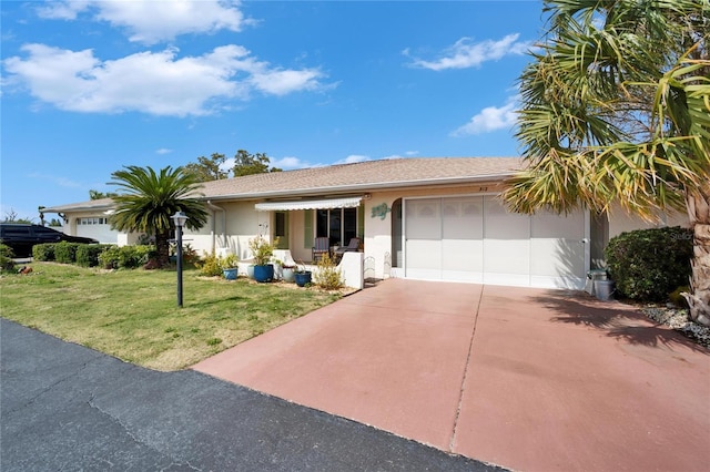 single story home with stucco siding, an attached garage, driveway, and a front yard