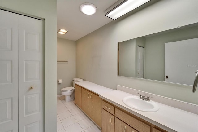 bathroom featuring a closet, tile patterned floors, toilet, and vanity