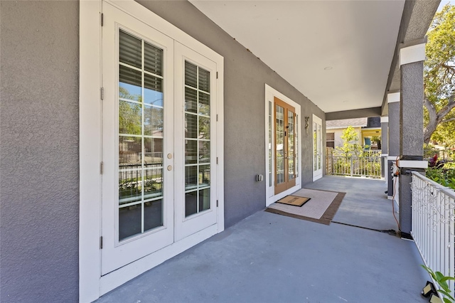 view of patio / terrace with french doors and covered porch