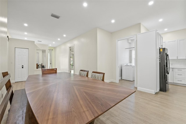 dining area with washer / clothes dryer, recessed lighting, and light wood-type flooring