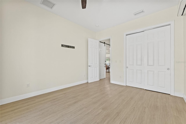 unfurnished bedroom with baseboards, visible vents, and light wood finished floors