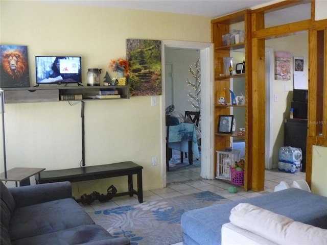 tiled living area featuring built in shelves