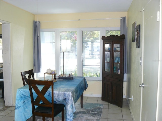 dining area with light tile patterned floors and baseboards