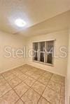 spare room featuring tile patterned flooring