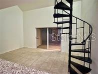 stairway with tile patterned floors