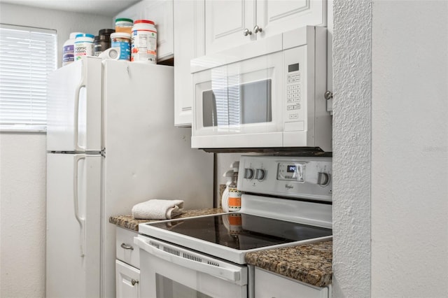 kitchen with white appliances and white cabinets