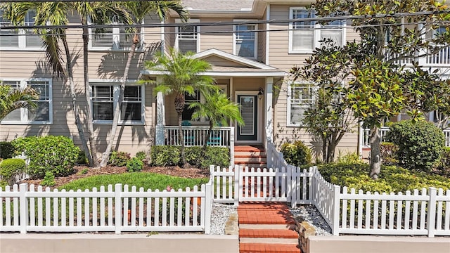 doorway to property featuring covered porch and fence