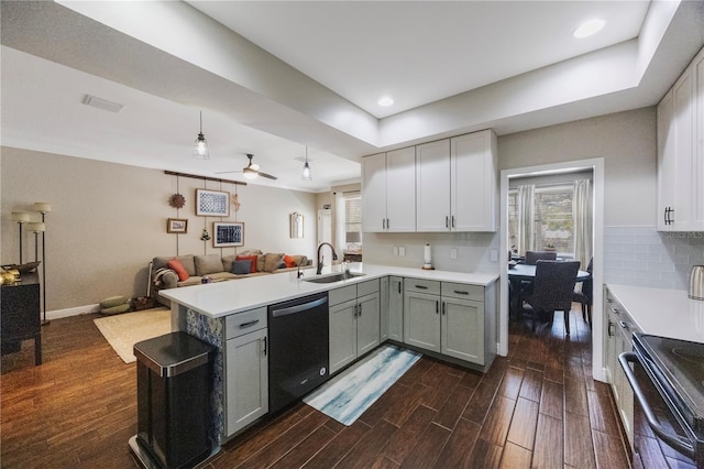 kitchen featuring open floor plan, dishwashing machine, a peninsula, electric range, and a sink