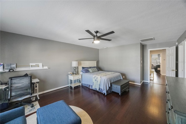 bedroom featuring visible vents, baseboards, and wood finished floors