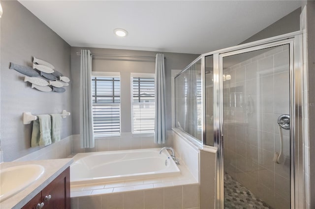 full bath featuring vanity, a garden tub, and a stall shower