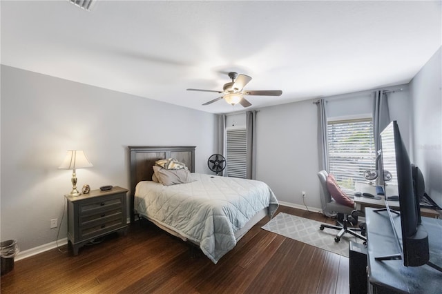 bedroom with ceiling fan, baseboards, and wood finished floors