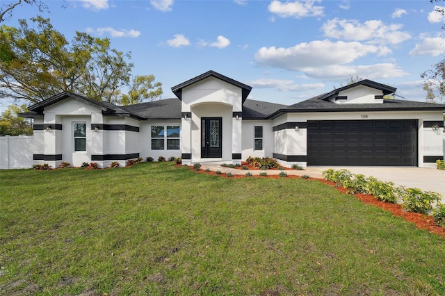 prairie-style house with a garage, driveway, a front yard, and stucco siding