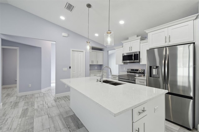 kitchen with visible vents, lofted ceiling, a sink, stainless steel appliances, and white cabinetry