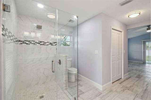 full bath featuring toilet, baseboards, visible vents, and a marble finish shower