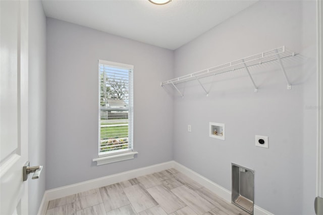 laundry room featuring electric dryer hookup, baseboards, hookup for a washing machine, and laundry area