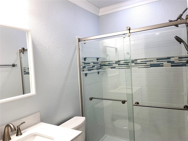 full bath featuring a shower stall, vanity, toilet, and crown molding