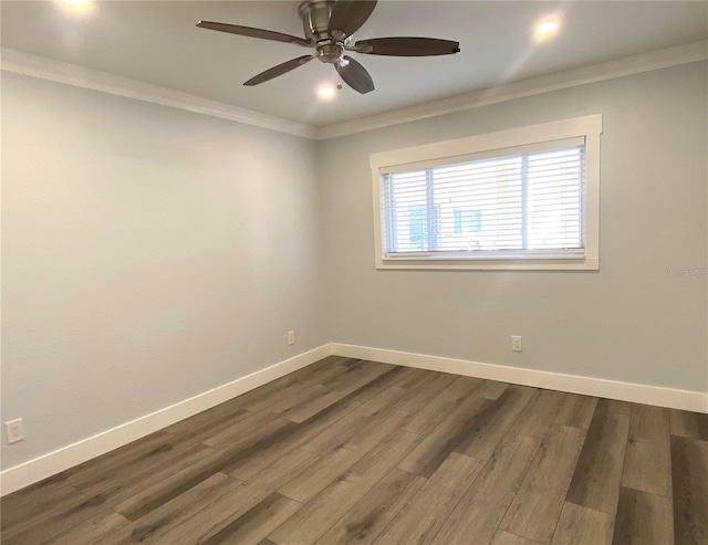 spare room with baseboards, dark wood-style flooring, and ornamental molding