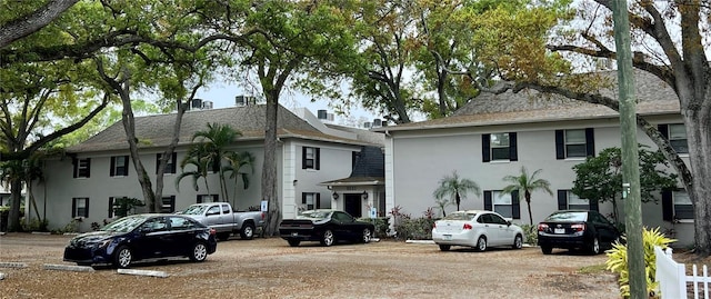 view of front of property featuring a shingled roof and stucco siding