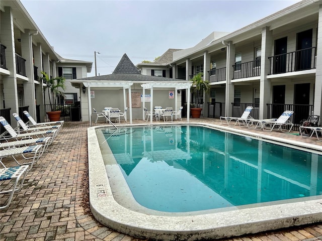 pool with fence and a patio area