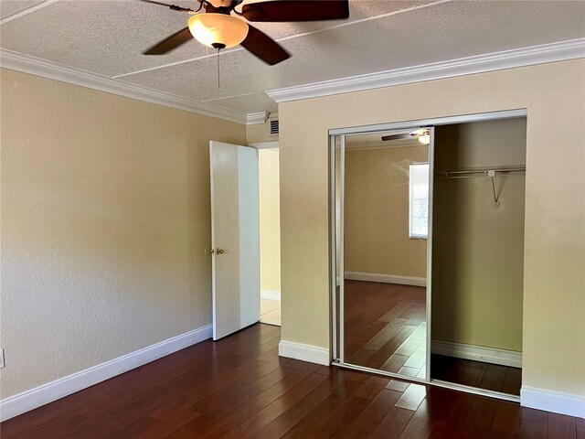 5221 Bayshore Blvd Unit 29, Tampa, FL 33611 - unfurnished bedroom featuring crown molding, baseboards, hardwood / wood-style floors, a closet, and a ceiling fan