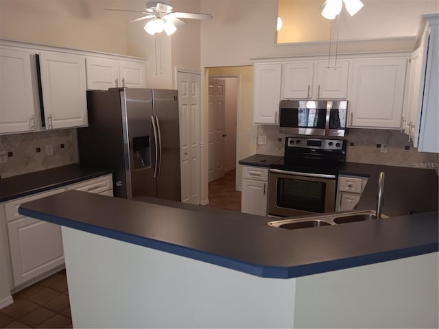 kitchen with stainless steel appliances, a ceiling fan, and white cabinetry