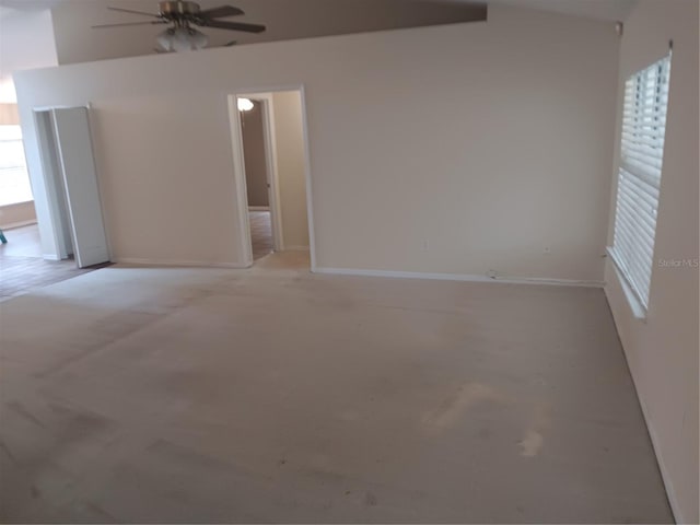 unfurnished room with baseboards and ceiling fan